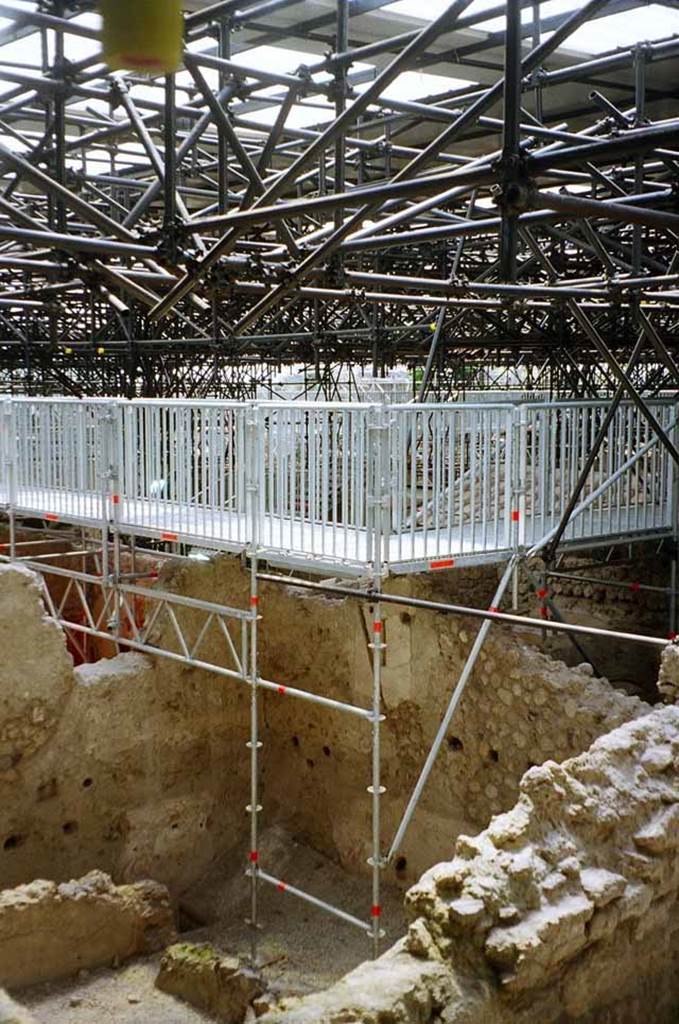 IX.12.9 Pompeii. May 2010. Room 13, looking north-west. Photo courtesy of Rick Bauer.
The kitchen area is to the right and the lararium paintings on the south and west walls and part of the bench with the building lime can be seen.
