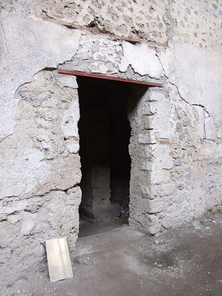 IX.12.9 Pompeii. December 2006. Street entrance to kitchen and latrine.
This would have been the secondary entrance of the house, to kitchen and latrine. 
The main entrance to the house is probably on the western side of the insula and has not yet been identified.
