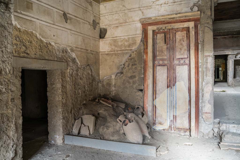 IX.13.3 Pompeii. October 2021. Room 1, north-west corner and painted doorway in north wall. Photo courtesy of Johannes Eber.