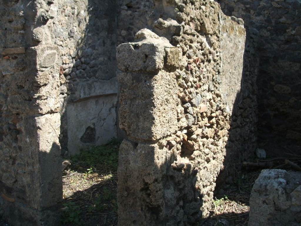 IX.14.4 Pompeii. May 2005. Rooms K and L on the east side of the corridor on the east of the tablinum. According to Sogliano, room K on the left was a cubiculum. The walls were decorated with white plaster, divided into large panels, but of this decoration nothing much remained. The recess for the bed can be seen in the north wall. The east part where the bed would have been had a low ceiling, the west part (the nearest end) would have had a barrel-vaulted ceiling, traces of which could still be seen then. In the north and south walls, the holes for the beam supports of an upper room could be seen. Room L on the right was the site of a wooden staircase to the upper floor, traces of which could be seen against the south wall. See Notizie degli Scavi, 1905, p.256-7).