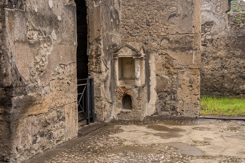 IX.14.4 Pompeii. July 2024. Aedicula lararium in north-west corner of atrium. Photo courtesy of Johannes Eber.