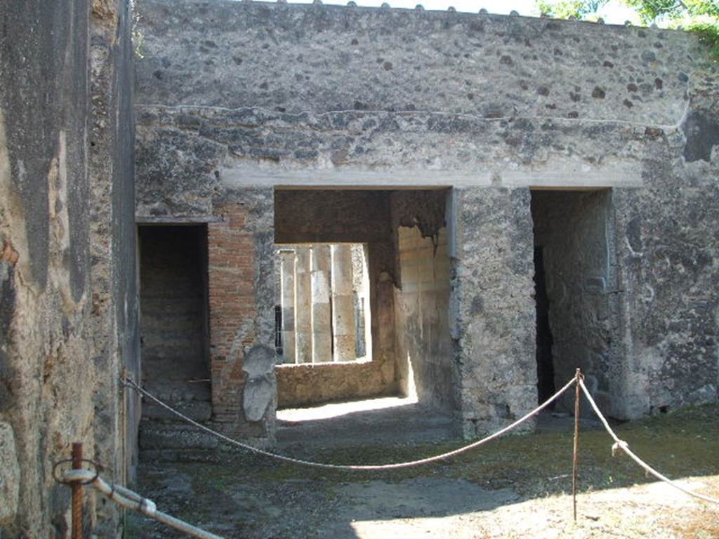 IX.14.4 Pompeii. May 2005. Room 27, the secondary atrium at IX.14.2, looking south to staircase, tablinum 19 and corridor (n). This area was excavated during June 1911. The floor of the atrium was made of concrete littered with chunks of white marble. Fragments of the wall decorations were found attached to the walls here and there. Renewal and restoration was being undertaken in 79AD. See Notizie degli Scavi, 1911, (p.267)

