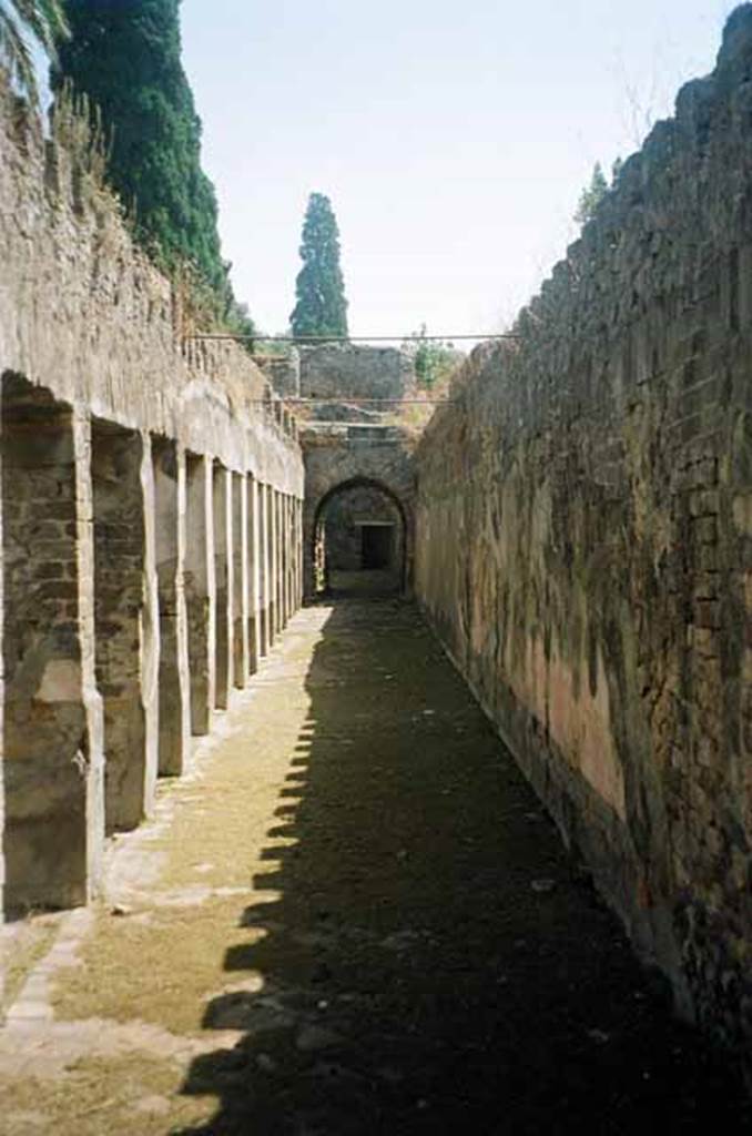 HGW24 Pompeii. July 2010. Looking east along south portico from south-west corner. 
Photo courtesy of Rick Bauer.
(Fontaine, No. 18 was found near room 5,2, in south-west corner of garden portico).
From PAH, addendum, p.122 – 
Relazione delle antichita, che si vanno ritrovando nella masseria del sig. D. Giovanni Milano parsonaro, che si era principiata al di 14 Febbraro 1771. (Report of Antiquities found.....)
 “No.18. A di 22 agosto 1771. Si e trovata una piastra come la descritta per uso di porta, ed e rotta in due cantoni; e tra la terra di quella vicinanza so sono trovate due monete di bronzo di diam. quasi uguali, on. 1 vantaggiata; in una vi e una testa circondata da iscrizione, e dal lato opposto S.C; ;’altra non si distingue per la ruggine.”
