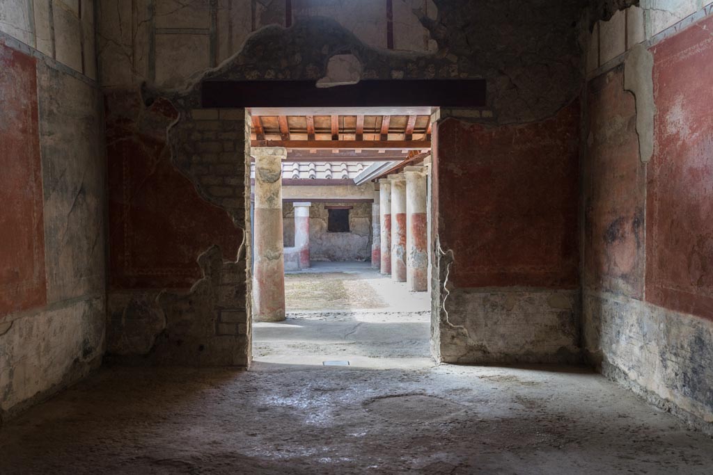 Villa Regina, Boscoreale. October 2021. 
Triclinium IV, looking towards south wall with doorway to portico VII. Photo courtesy of Johannes Eber.
