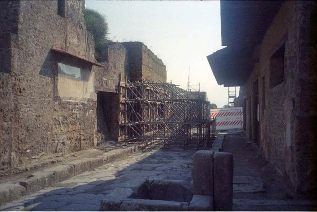 Via dell’Abbondanza, July 2011. Looking east between III.2 and I.12, from near fountain and I.12.1/2, on right. III.2.3 can be seen at the rear of the scaffolding. Photo courtesy of Rick Bauer.
