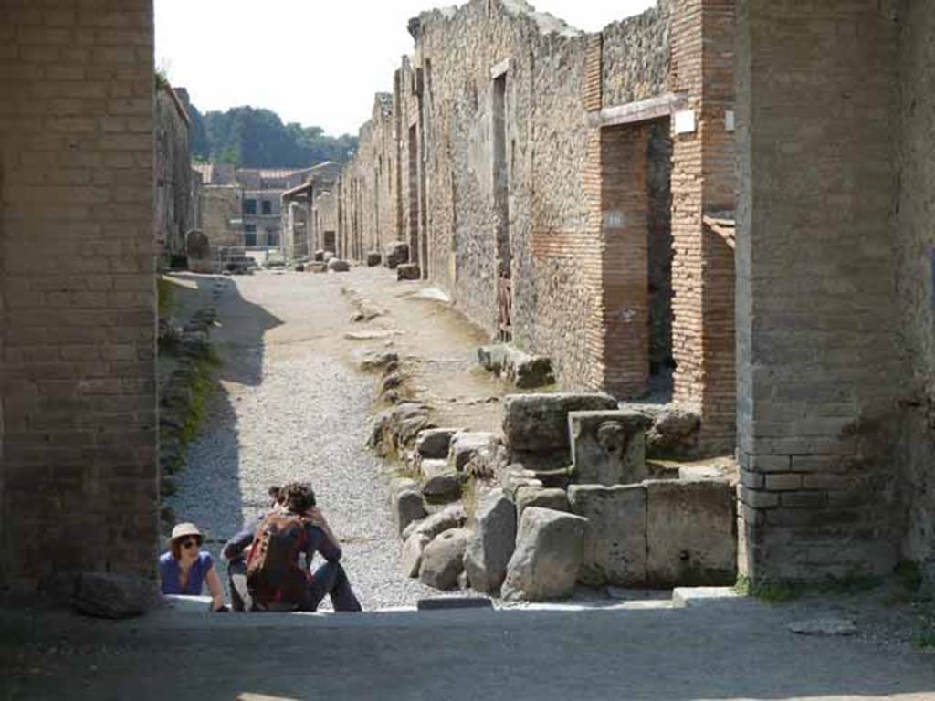 Via di Castricio, May 2010. Looking west from between II.9 and II.1, across the junction with Via di Nocera, to between I.14 and I.13