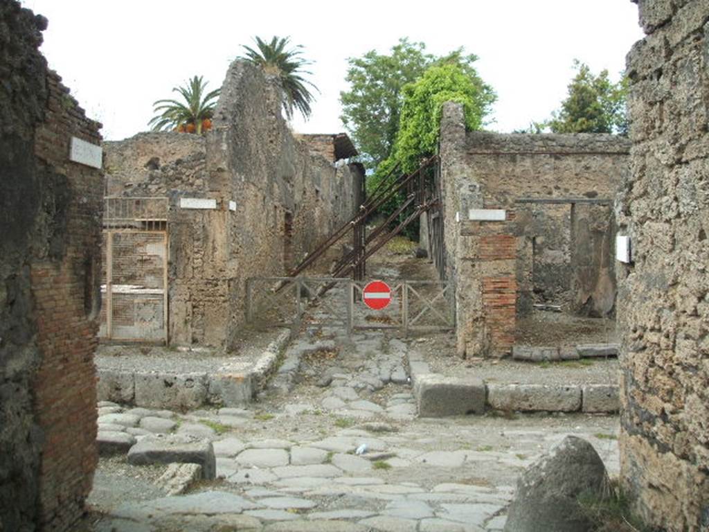 Via di Nola between V.4 and V.5. Looking north across junction to Vicolo dei Gladiatori from unnamed vicolo. May 2005.