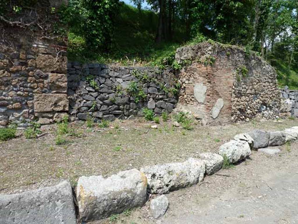 Via di Nola, north side, May 2010.  Looking north between IV.4 and IV.5, unexcavated, unnamed vicolo.