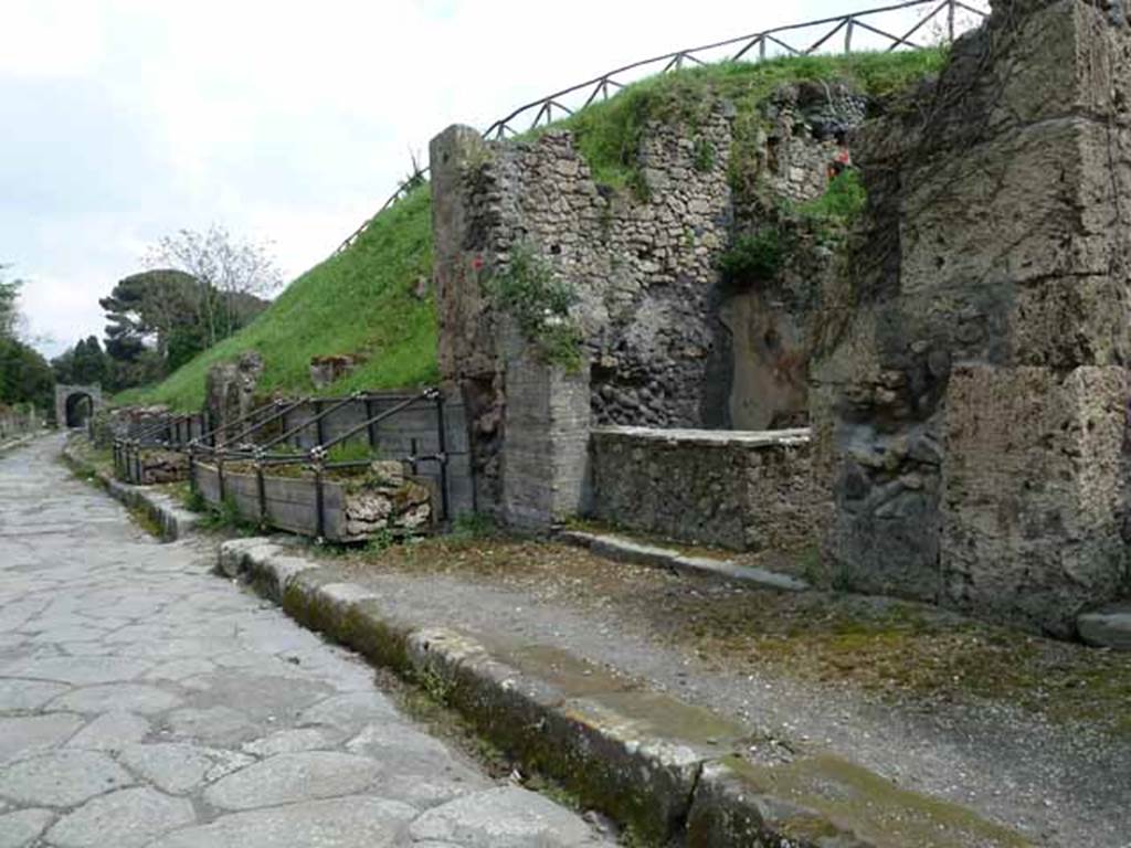 Via di Nola, south side, May 2010.  Looking east from III.8.8, towards unexcavated roadway between III.9 and III.8.