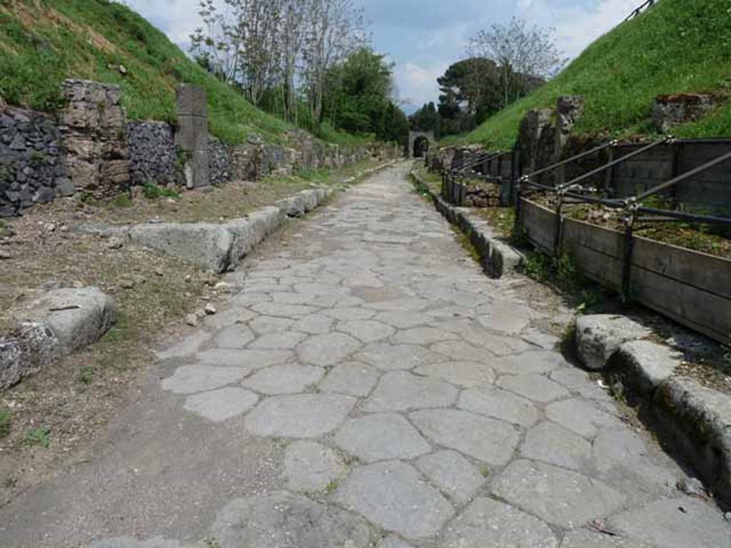 Via di Nola, May 2010.  Looking east between IV.3 and III.9, from junction with unexcavated vicoli to both north and south.