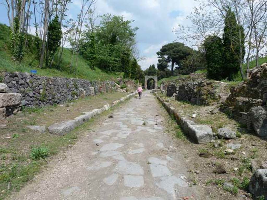 Via di Nola, May 2010.  Looking east between IV.4 and III.10 from crossroads with two unexcavated unnamed vicoli.