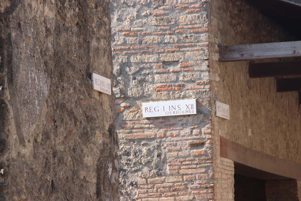 Vicolo dei Fuggiaschi, September 2017. Insula identification plaques between I.13 and I.12, the roadway known as Vicolo dei Fuggiaschi
On the left, plaque on I.13.1, previously known as Reg. II, Ins.111.1
On the right, plaque on I.12.5, previously known as Reg. II, Ins. 11 (which is Reg. II, Ins. 2.5). 
Photo courtesy of Klaus Heese.
