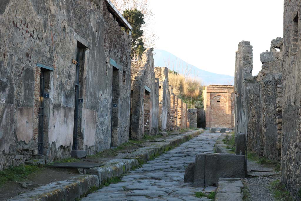 Vicolo dei Vettii between VI.15 and VI.16. December 2018. 
Looking north from VI.15.7, on left, towards VI.15.18, in centre near water tower. Photo courtesy of Aude Durand.
