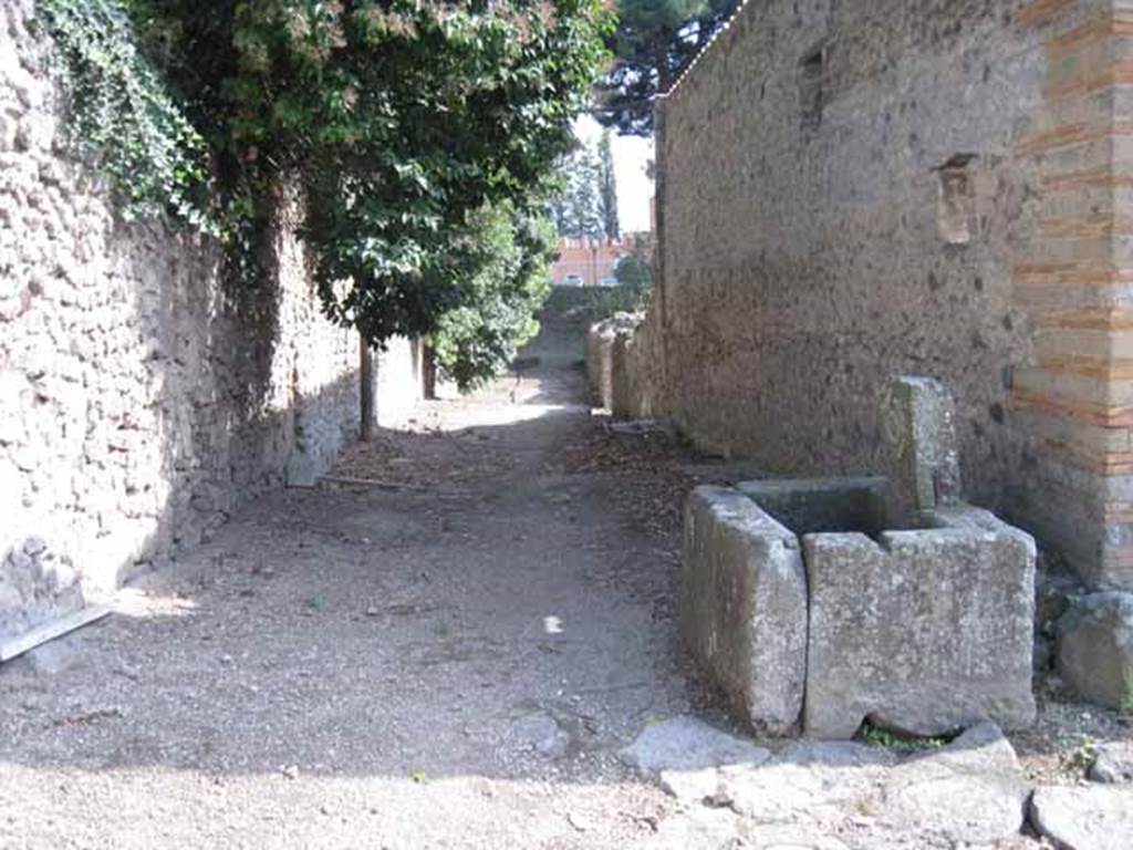 Vicolo del Citarista (on left) between I.25 (unexcavated) and I.5. September 2010. Looking south from Vicolo del Conciapelle.  Photo courtesy of Drew Baker.

