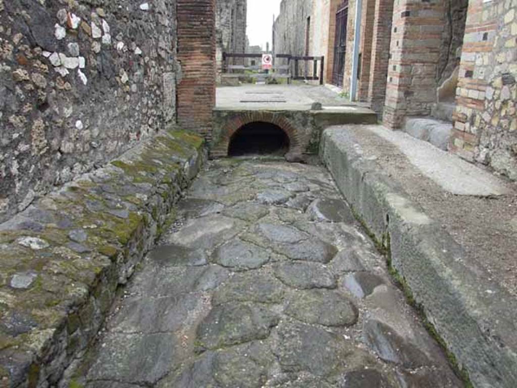 Vicolo del Farmacista. May 2010.  Looking south to drain under road junction with Via delle Terme.