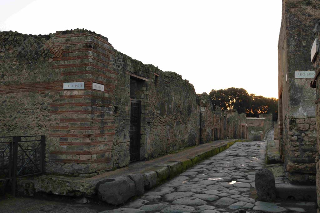 Vicolo del Menandro, south side at I.3.24 (centre left) and junction with Vicolo del Citarista. December 2018. 
Looking west along I.3. Photo courtesy of Aude Durand.
