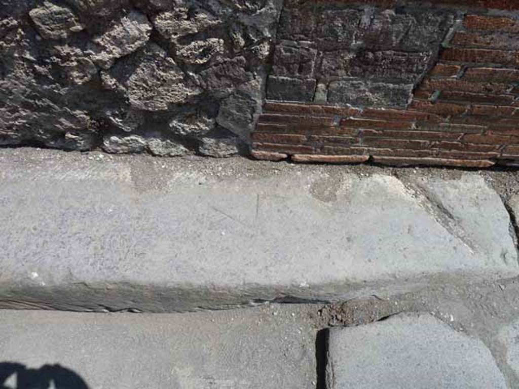 Vicolo della Maschera, east side, May 2010. Mason’s marks in road edging.