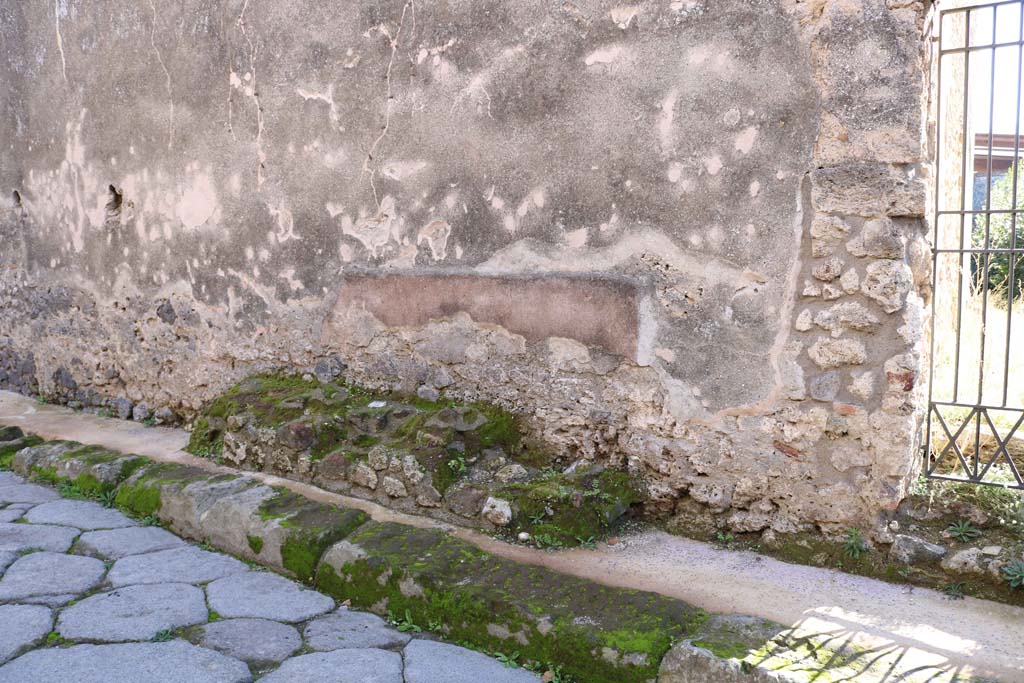 Vicolo di Balbo, south side, Pompeii. December 2018. 
Looking south towards structure on pavement near doorway to IX.1.30, on right. Photo courtesy of Aude Durand.
