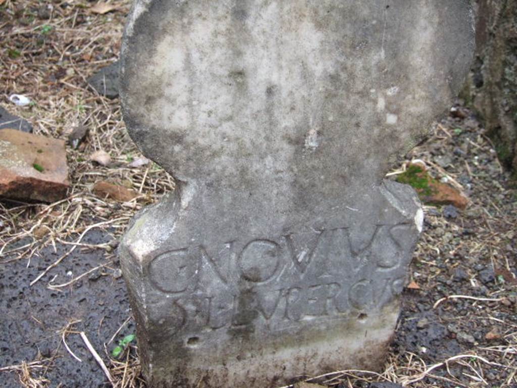 FPNE Pompeii. December 2005. Columella at south-west corner of arched monument, with inscription
C. NOVIVS
). L. LVPERCVS.

D’Ambrosio and De Caro expand this to:
C(aius) Novius
G(aiae) l(ibertus) Lupercus

See D’Ambrosio A. and De Caro S., 1988. Römische Gräberstraßen. München: C.H.Beck. p. 208.