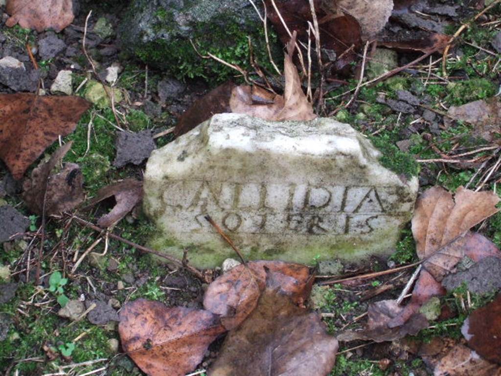 FPSG Pompeii. December 2005. Marble columella of Callidia Soteris.
This has the inscription 

CALLIDIA 
SOTERIS.

On the back (the upper part is now missing) was a parting line and a bun, schematically represented as an incised triangle.
See D’Ambrosio A. and De Caro S., 1988. Römische Gräberstraßen. München: C.H.Beck. p. 225, taf. 39d.