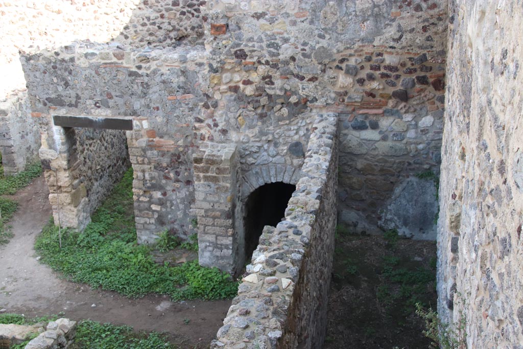 HGW24 Pompeii. Villa of Diomedes. October 2023. 
Looking east towards doorway to room 7,7, arched entrance, and east end of passageway 6,b. Photo courtesy of Klaus Heese.
