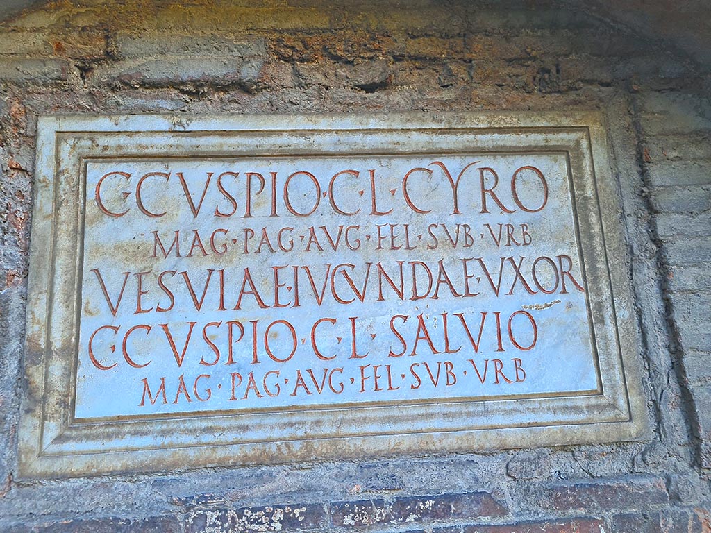 Pompeii Porta Nocera. October 2024. Tomb 17ES. Marble plaque with Latin inscription. Photo courtesy of Giuseppe Ciaramella.

C(aio) CVSPIO C(ai) L(iberto) CYRO
MAG(istro) PAG(i) AVG((usti) FEL(icis) SVB VRB(anis)
VESVIAE IVCVNDAE VXOR(i)
C(aio) CVSPIO C(ai) L(iberto) SALVIO
MAG(istro) PAG(i) AUG((usti) FEL(icis) SVB VRB(anis).

Caius Cuspius Cyrus and Caius Cuspius Salvius were both freedmen of Caius Cuspius.
Vesvia Iucunda the wife of C. Cuspius Cyrus would appear also to be free.
Both men would appear to have been magistrates/priests of the Pagus Augustus Felix Suburbanus.
