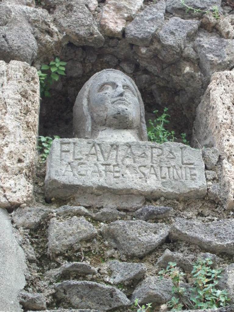 Pompeii Porta Nocera. May 2006. Tomb 7OS. Bust of a woman with inscription on base.
FLAVIA P(ubli) L(iberta)
AGAT(h)EA SALINIE(nsis)
Flavia Agathea was “from the saline area”.
Saliniensis would seem to refer to the stretch of coast between Torre Annunziata and Castellamare.
See D’Ambrosio, A. and De Caro, S., 1983. Un Impegno per Pompei: Fotopiano e documentazione della Necropoli di Porta Nocera. Milano: Touring Club Italiano. (7OS)
