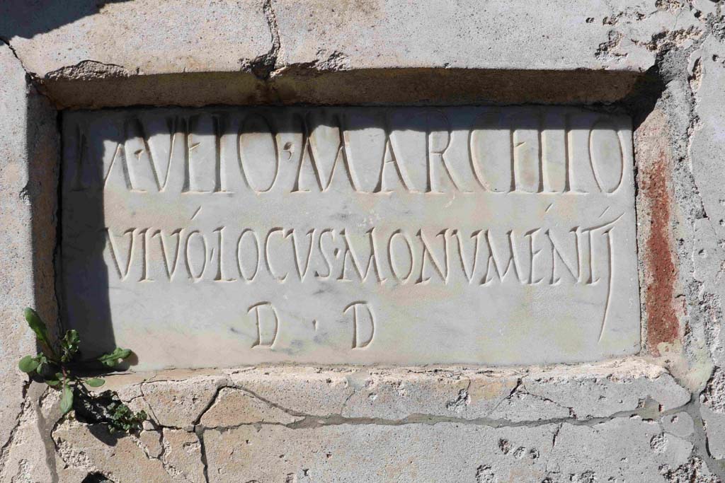 Pompeii VGI. February 2020. Marble plaque with Latin inscription. Photo courtesy of Aude Durand.
It reads -
M(arco) VEIO MARCELLO
VIVO LOCVS MONVMENTI
D(ecreto) D(ecurionum).
The tomb was still incomplete at the time of the eruption in 79 AD.
See La Rocca, de Vos, de Vos, 1981. Guida Archeologica di Pompei; II Edizione. Milano: Arnoldo Mondadori Editore.  (p. 280).

