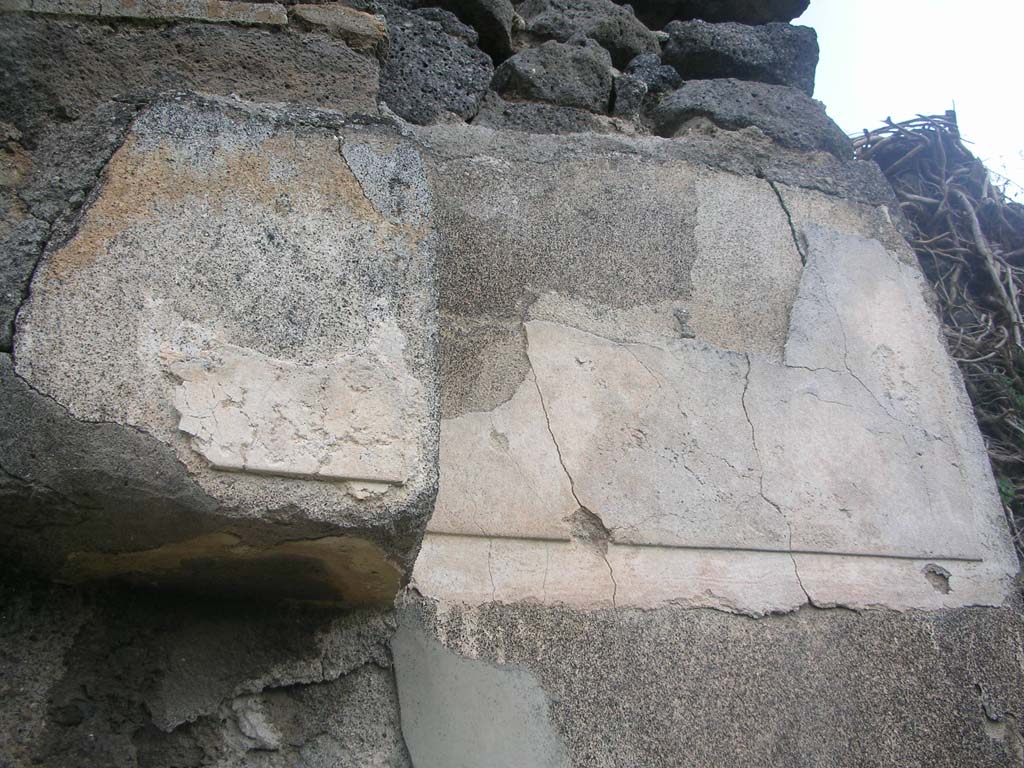 Tower XI, Pompeii. May 2010. Detail of remaining decoration on upper east side of doorway. Photo courtesy of Ivo van der Graaff.