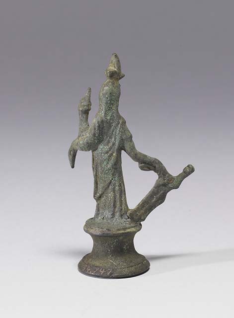 Boscoreale, Villa rustica in fondo DAcunzo. Room 12, lararium. 
Bronze statuette of Isis-Fortuna, 0.09m high including the base, front view.
She is fully clothed and has a crescent moon and a disk surmounted by two plumes upon her forehead.
In her right hand she holds a rudder, in her left hand a cornucopia.
Photo courtesy of The Walters Art Museum, Baltimore. Inventory number 54.747.
http://thewalters.org/
Creative Commons Attribution-ShareAlike 3.0 Unported Licence
