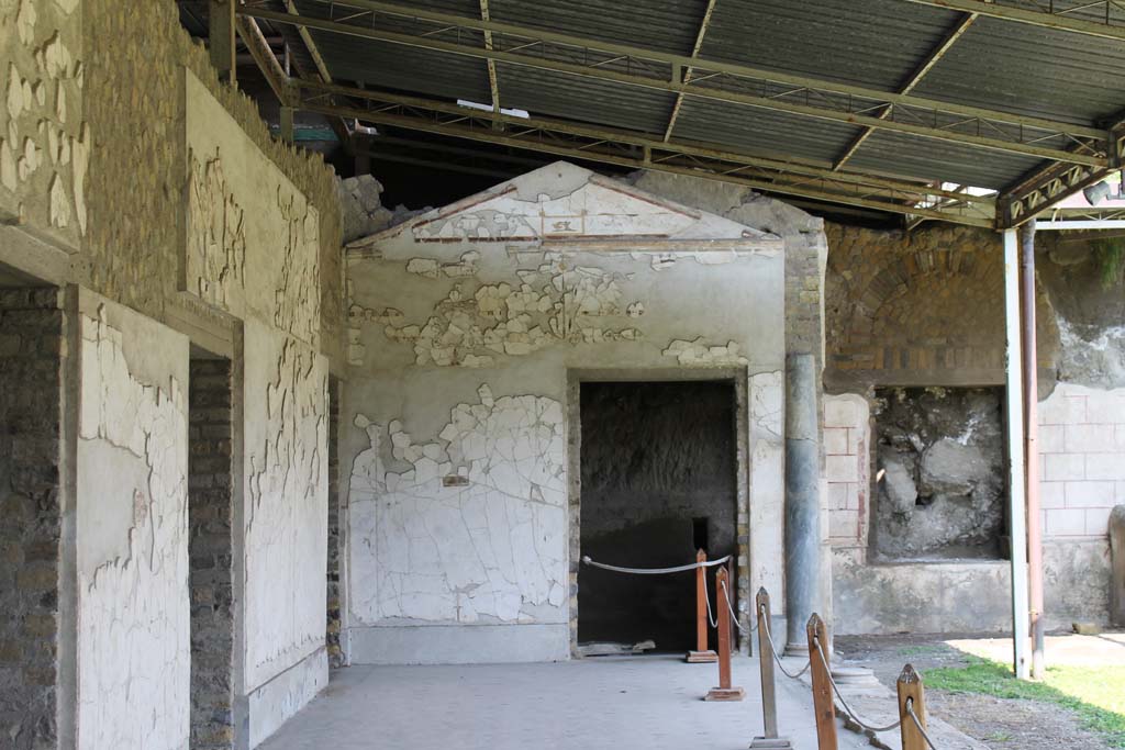 Oplontis Villa of Poppea, March 2014. Area 60, the west portico of the swimming pool.
This is the eastern doorway to room 97, at the north end of the portico, looking through doorway into the unexcavated. 
On the right is the window with the decoration under it. 
Foto Annette Haug, ERC Grant 681269 DÉCOR.
