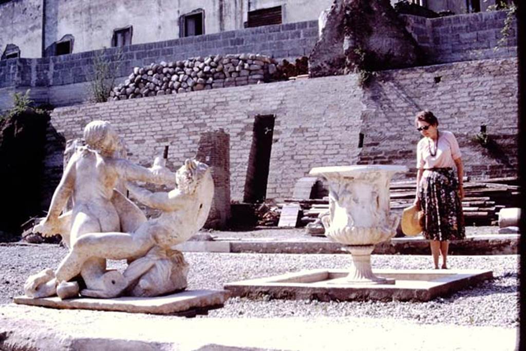 Oplontis, 1978. Area 92, Wilhelmina studying the items on the south side of pool. Photo by Stanley A. Jashemski.   
Source: The Wilhelmina and Stanley A. Jashemski archive in the University of Maryland Library, Special Collections (See collection page) and made available under the Creative Commons Attribution-Non Commercial License v.4. See Licence and use details. J78f0051
