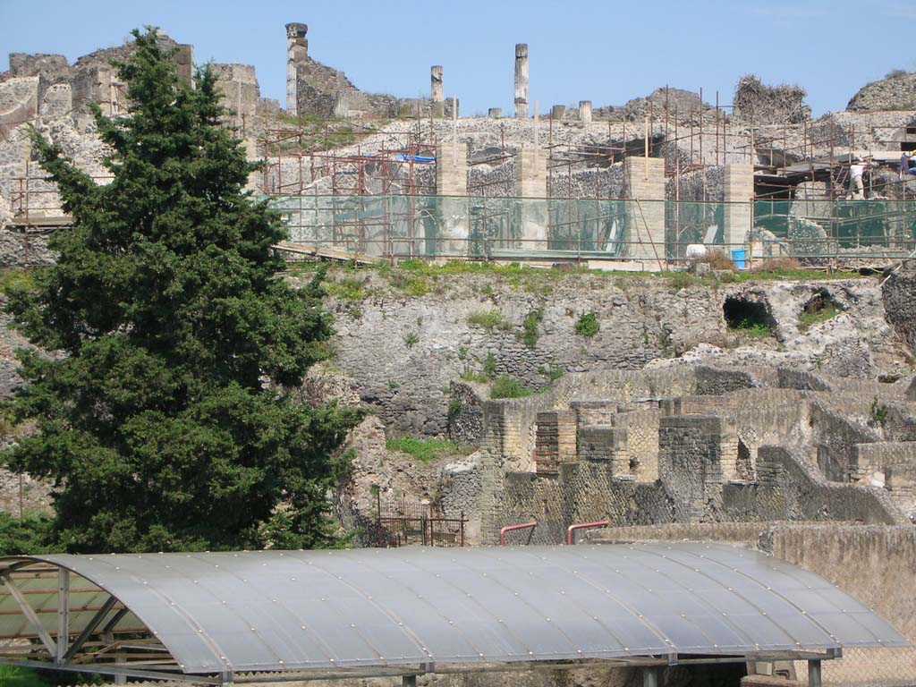 Walls on west side of Pompeii. May 2010. 
Looking east to City Walls, below VII.16.15, and above roof of Suburban Baths. Photo courtesy of Ivo van der Graaff.
